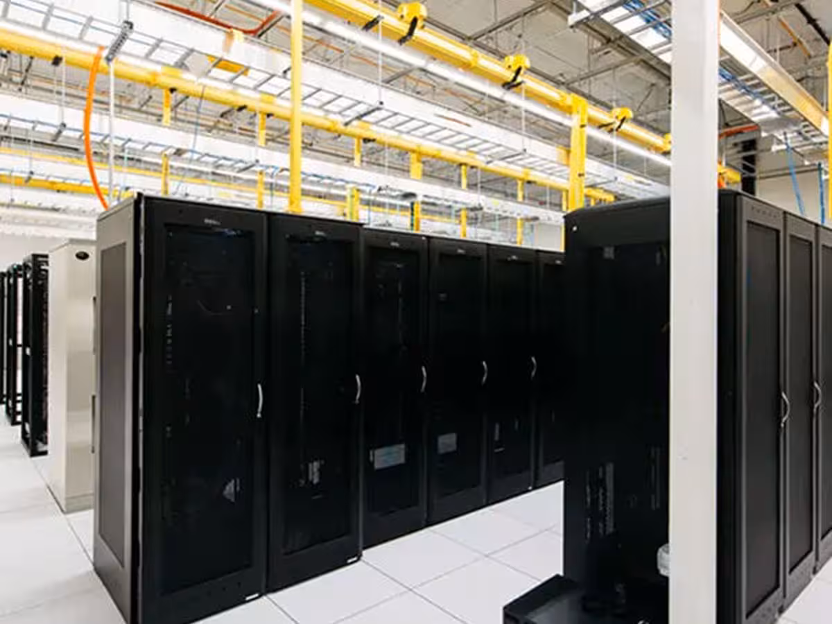 Rows of server racks under overhead cable trays in the Tampa, FL datacenter